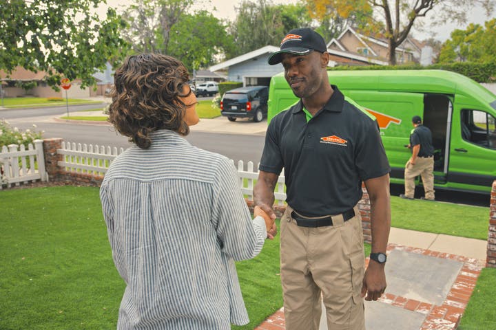 A homeowner and SERVPRO employee shaking each other's hands.